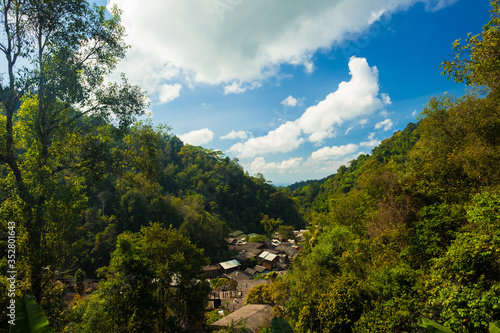 A local village surrounded by green forests landscape in Thailand