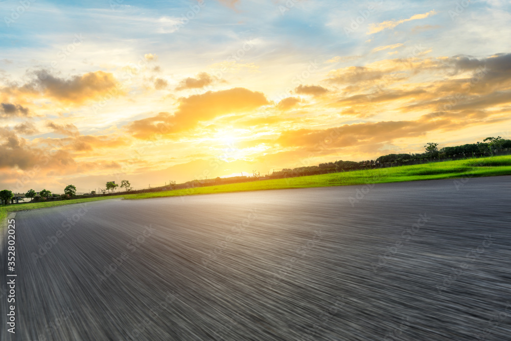 Fast moving asphalt highway and green forest at sunset. Fast moving asphalt highway and green forest at sunset.
