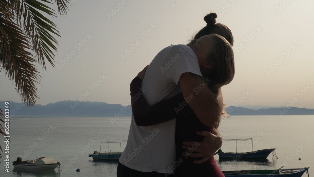 Yoga massage teacher hug student at seaside place. Yoga massage teacher hug student at seaside place.