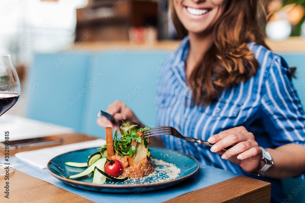 Young beautiful and happy woman enjoying in delicious meal in luxurious restaurant. Young beautiful and happy woman enjoying in delicious meal in luxurious restaurant.