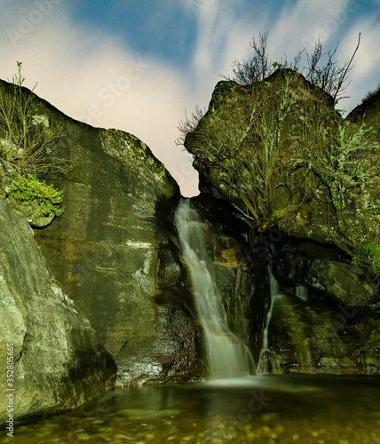 Waterfall Night Photograph with stars and clouds