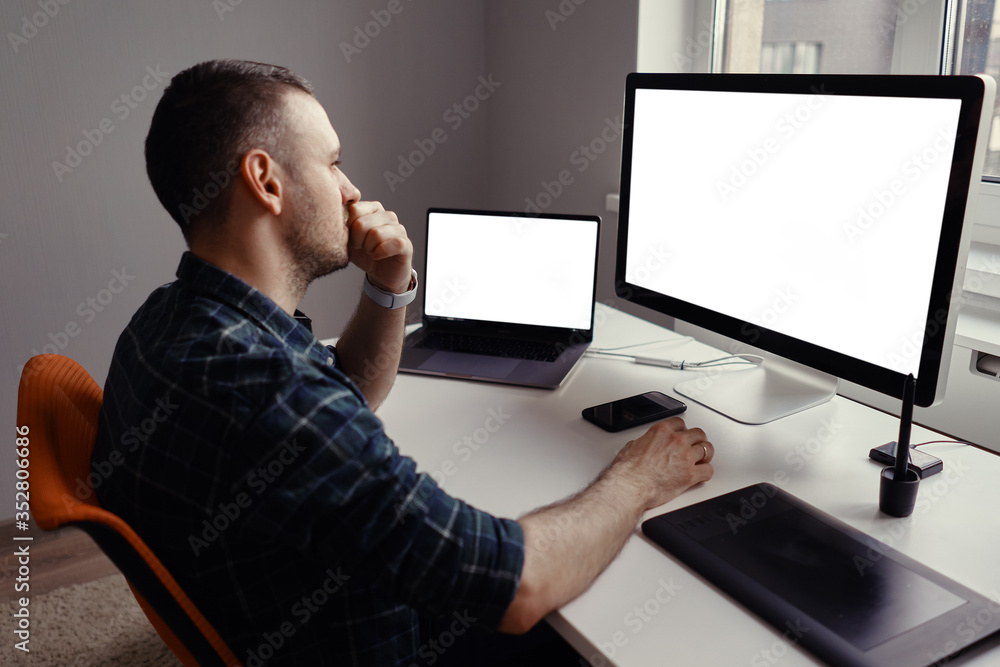 Young man working on his laptop with blank copy space screen for your advertising text message at home. Home office Young man working on his laptop with blank copy space screen for your advertising text message at home. Home office