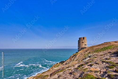 Image of German WW2 bunker and gun emplacement on the North West coast early sunny morning with blue sky, Jersey, Channel Islands, uk