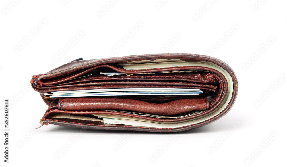 Old brown leather wallet with banknotes and credit cards isolated on white background. File contains a path to isolation. Old brown leather wallet with banknotes and credit cards isolated on white background. File contains a path to isolation.
