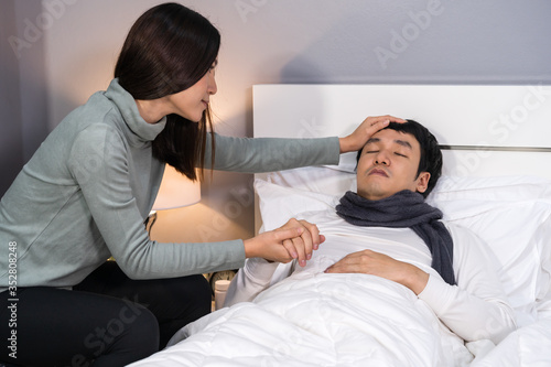 wife visiting and take care her sick husband while he sleeping on bed at home