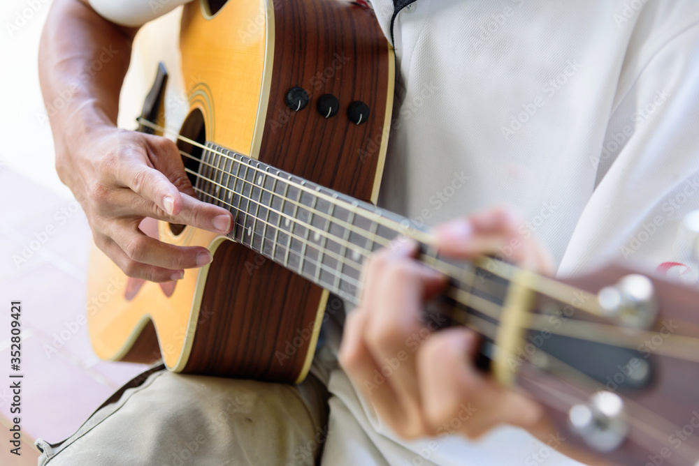Fototapeta premium playing acoustic guitar in the park