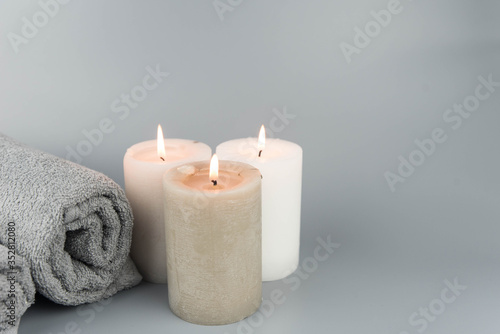 Towel with aromatic candles. Aromatherapy and beauty. Concept set of harmony, massage, balance and meditation, spa, relax, beauty spa treatment.
