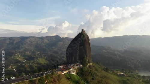 Forward Flying Aerial Cinematic Shot of El Peñol Rock At Guatapé Colombia During Golden Hour Sunset photo