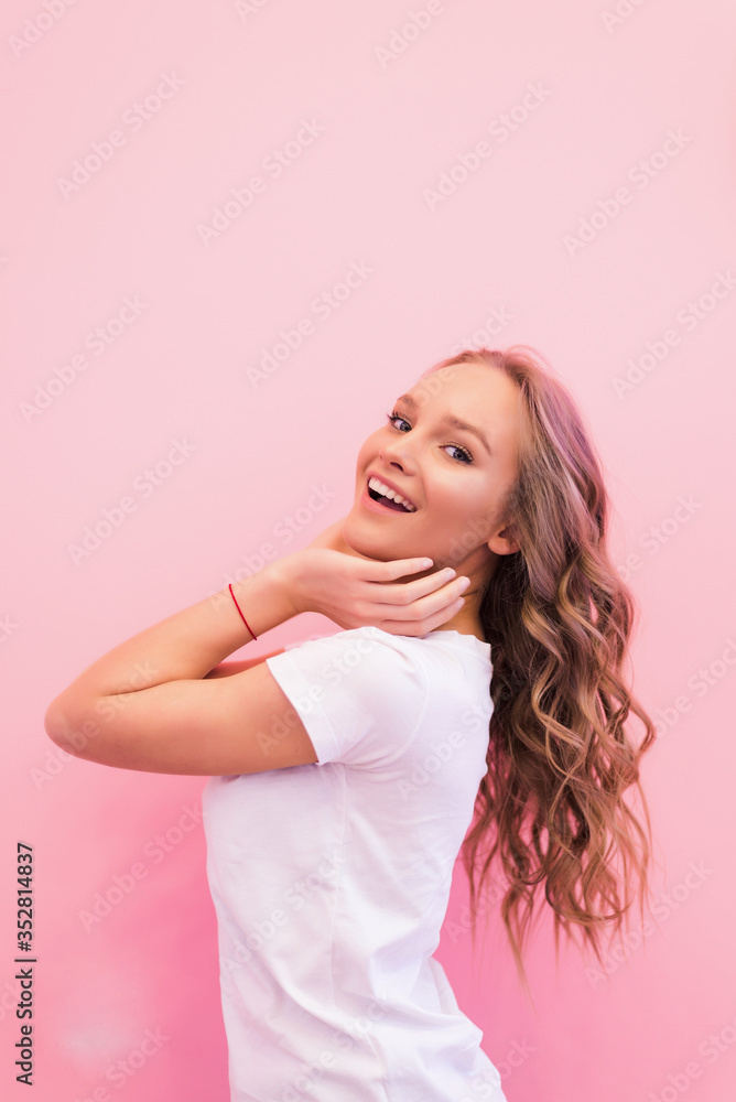 Blonde woman with curly beautiful hair smiling isolated on pink background. Blonde woman with curly beautiful hair smiling isolated on pink background.