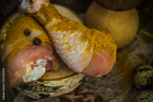 chicken leg with lemon and quail eggs on a dark background