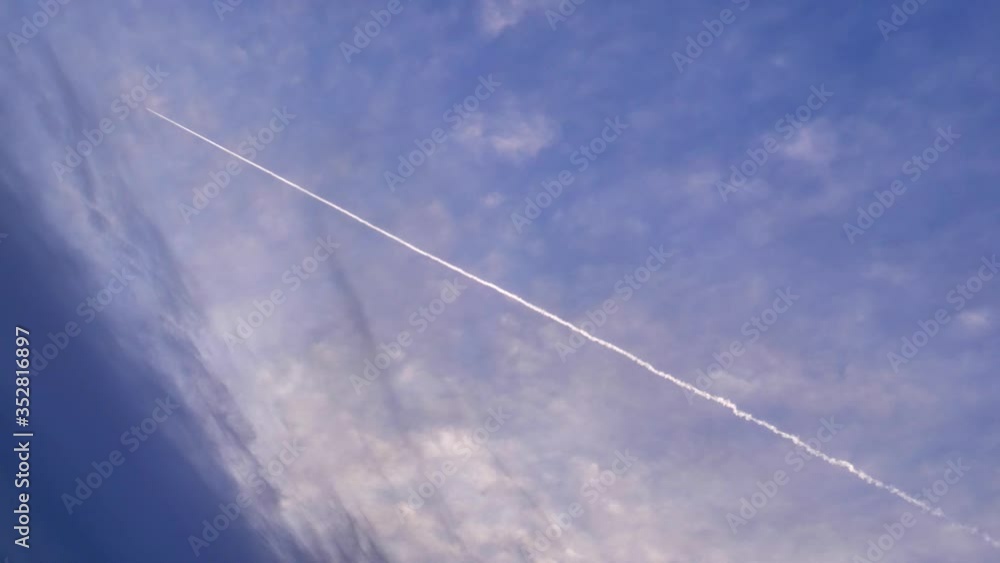 Trace of an airplane against blue sky Trace of an airplane against blue sky