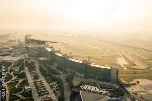 Photography Aerial view of the Meydan racecourse complex during sunrise