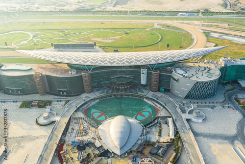 Photography Aerial view of the Meydan racecourse complex during sunrise