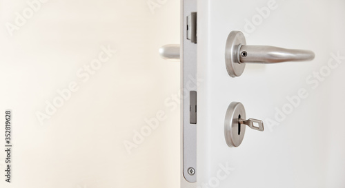 Zimmertür mit Klinke und Schlüssel im Türschloss