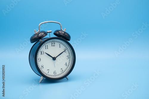 Alarm clock on blue background with copy space for you design.