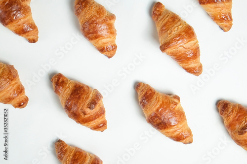 Studio shot of appealing plain mini croissant baked to golden crisp isolated on white backgroud. Traditional french pastry. Close up, copy space, top view.
