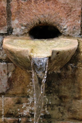 water flowing from a fountain © aldem