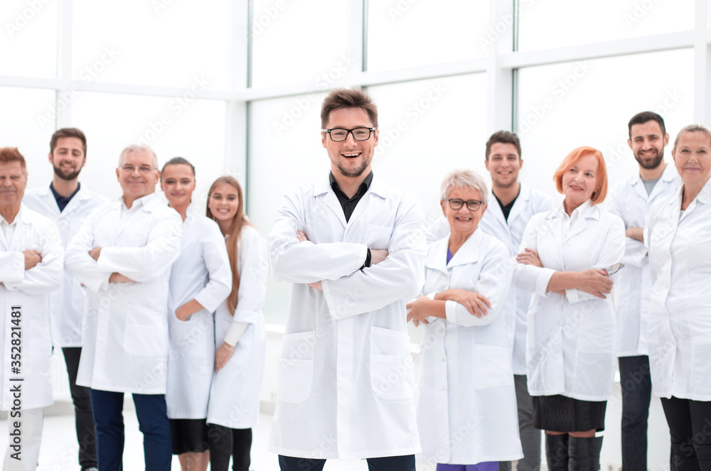 confident scientific leader standing in front of a team of young scientists. confident scientific leader standing in front of a team of young scientists.