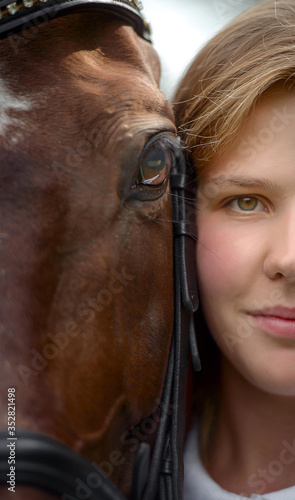 Girl's And Horse's Eyes close-up portrait fragment.