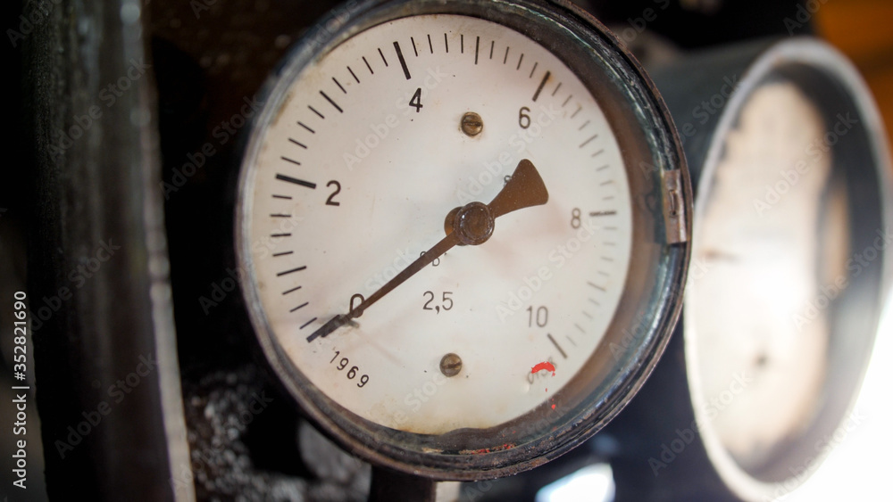 Closeup photo of manometers showing steam pressure in old steam power train engine