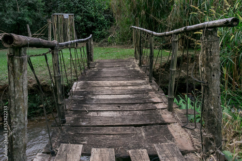 Fototapeta Naklejka Na Ścianę i Meble -  wooden bridge full of dangerous repairs