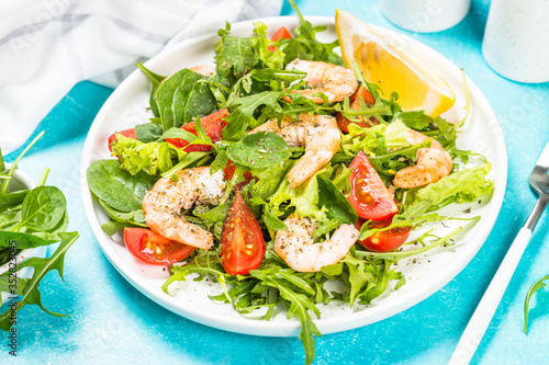 Shrimp salad with vegetables and leaves.