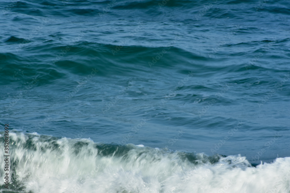 Blue sea That is a wave, because the strong wind causes the beautiful water to rise Blue sea That is a wave, because the strong wind causes the beautiful water to rise