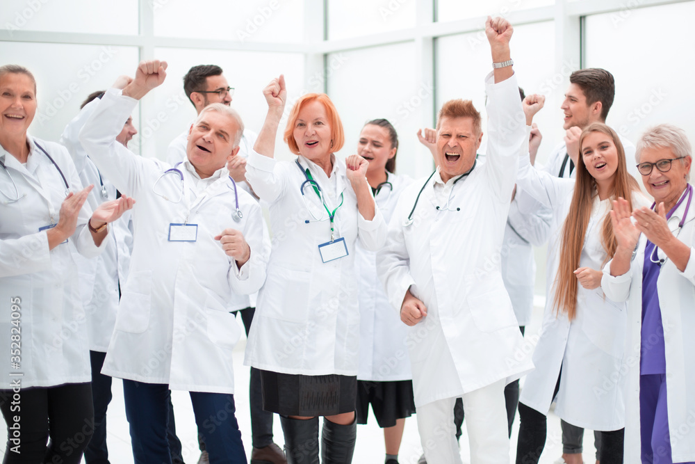 group of medical colleagues applauding their overall success. group of medical colleagues applauding their overall success.