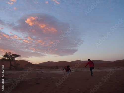 Women running towards Deadvlei to watch the morning sun  Namibia