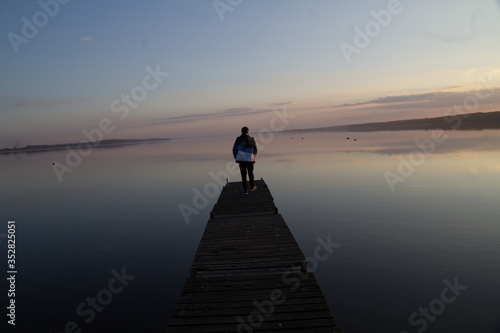 silhouette of man standing on the pier