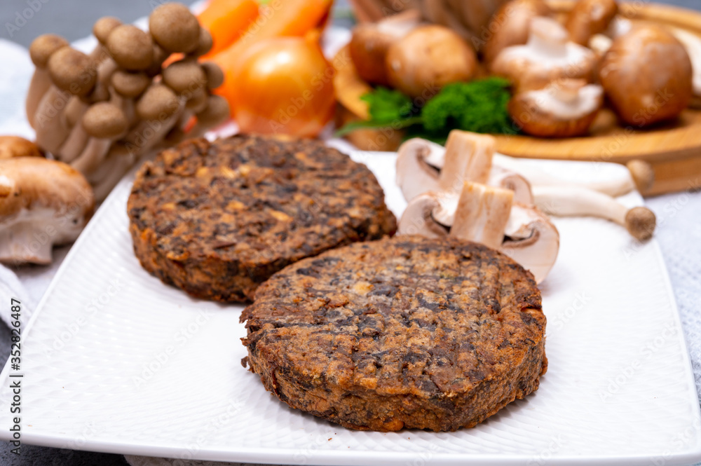 Tasty vegetarian food, burgers with champignons mushrooms, buna shimeji, carrot and onion