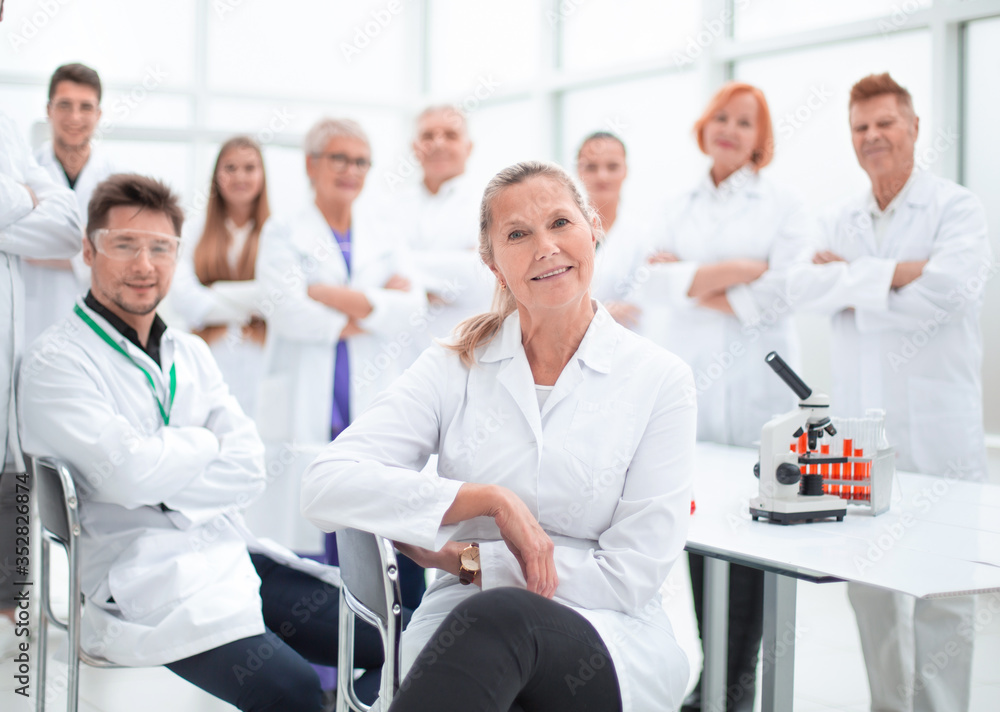 Fototapeta premium research supervisor and a group of young scientists in the workplace .