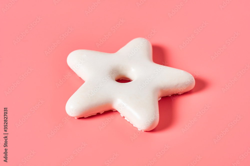 Festive christmas cookie in shape of star on pink background. New year celebration concept Festive christmas cookie in shape of star on pink background. New year celebration concept
