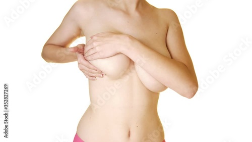 Breast Self Exam - BSE . Woman checking her breast for signs of breast cancer. photo