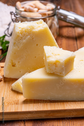 Pieces of matured pecorino romano italian cheese made from sheep milk in Lazio, Sardinia or Tuscany