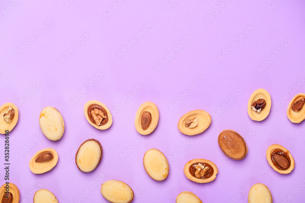 Homemade Russian nuts with condensed milk on a light pink background, wafer napkin. Cut nuts with condensed milk. Bitten goodies for coffee. Homemade Russian nuts with condensed milk on a light pink background, wafer napkin. Cut nuts with condensed milk. Bitten goodies for coffee.