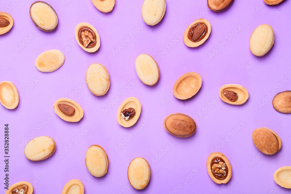 Homemade Russian nuts with condensed milk on a light pink background, wafer napkin. Cut nuts with condensed milk. Bitten goodies for coffee. Homemade Russian nuts with condensed milk on a light pink background, wafer napkin. Cut nuts with condensed milk. Bitten goodies for coffee.