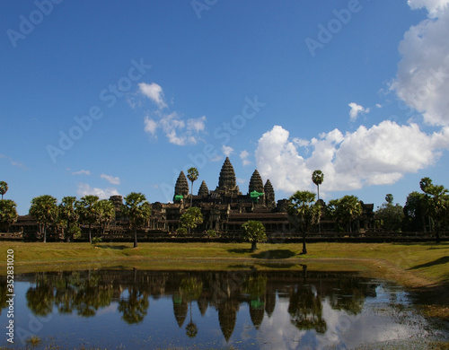 Angkor wat reflection in the lake with clear blue sky and white cloudy