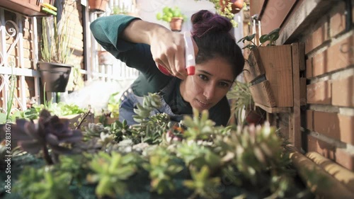 Woman working on garden with spray