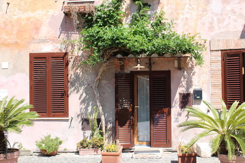 view of old house covered with creepers in street of old town near rome italy