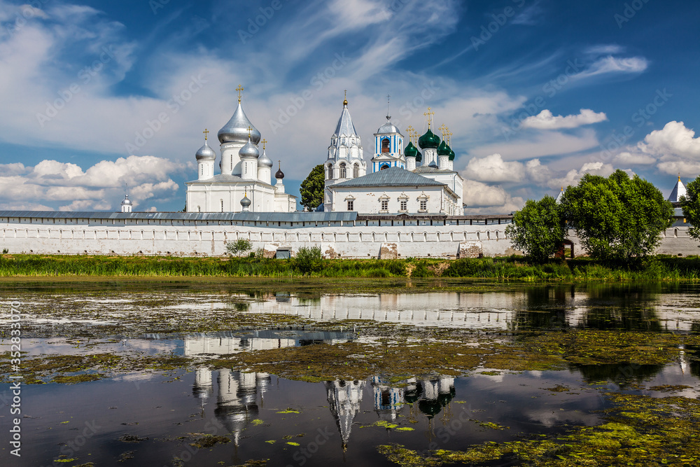 Nikitsky male orthodox monastery (11th century) and its reflection in the pond. Pereslavl Zalessky, Yaroslavl region, Russia