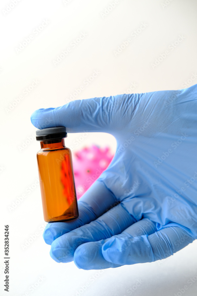 A brown bottle with a virus. Conceptual photo for illustration of coronavirus or Covid-19 A brown bottle with a virus. Conceptual photo for illustration of coronavirus or Covid-19