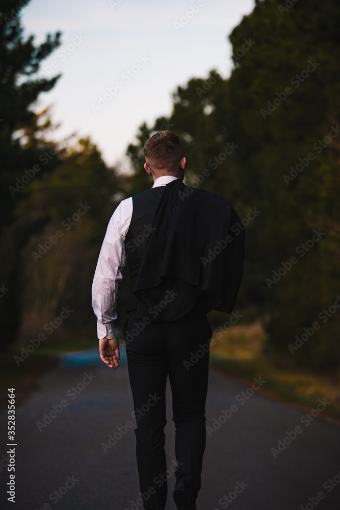 Guy walking down the street in a suit. Guy walking down the street in a suit.