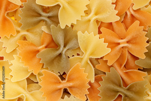 Background from multi-colored pasta. Natural product. Vegetarian. Close-up. Concept for food advertising.