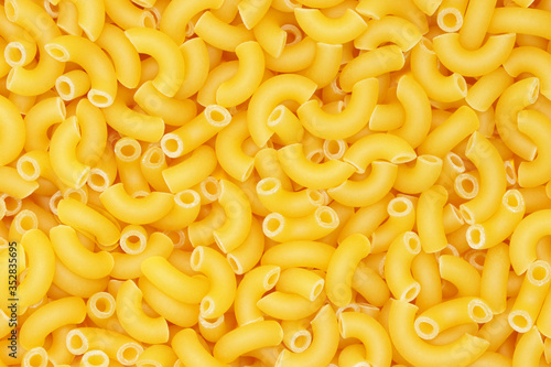 Background from pasta. Horns. Natural product. Close-up. Concept for food advertising.