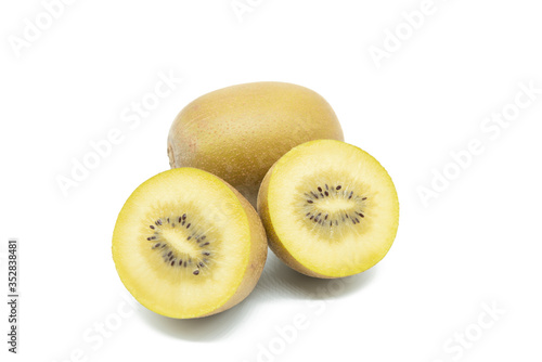 Whole and cut in half golden kiwi fruit isolated on white background