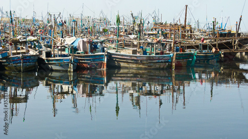 reflection of rows boats in on the river