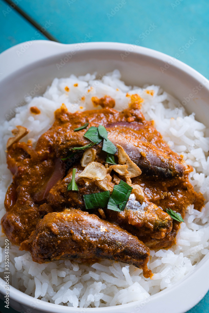 tomato sardines with crab fat on topped of rice or also known as aligue rice in the Philippines tomato sardines with crab fat on topped of rice or also known as aligue rice in the Philippines