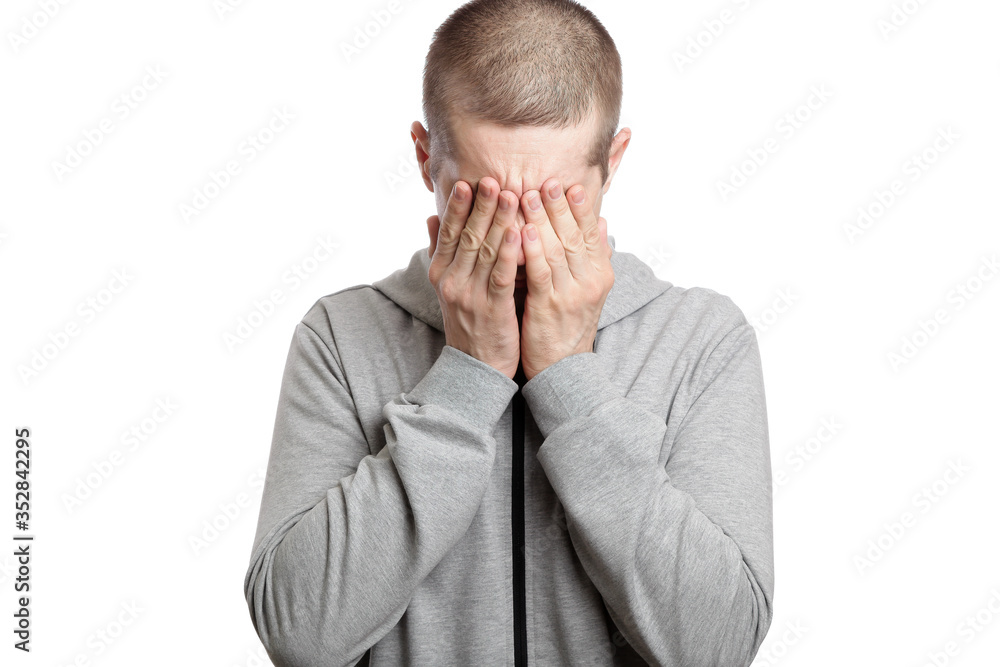 tired man covered his face with his hands, with sadness and distress. Dressed in sportswear. Isolated tired man covered his face with his hands, with sadness and distress. Dressed in sportswear. Isolated