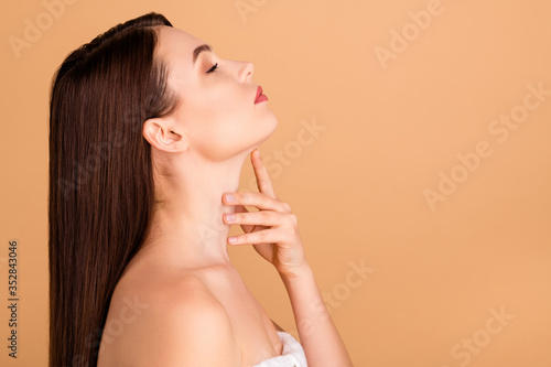 Profile side photo of dreamy gorgeous girl touch her neck enjoy her skin after bodycare lotion shower cream isolated over pastel color background